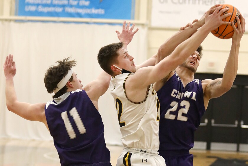 UW-Superior’s Joey Barker (22) fights for a rebound with Crown’s Cade Neubert (22)