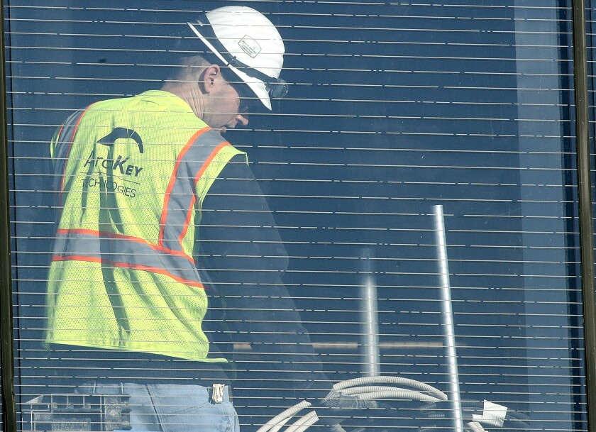 A man works inside a building under construction.
