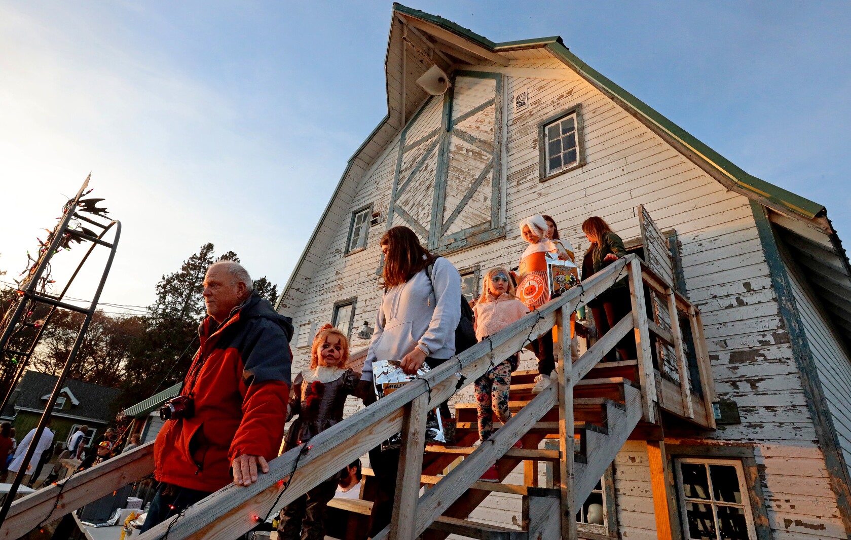 People go walk down the stairs from the haunted barn.