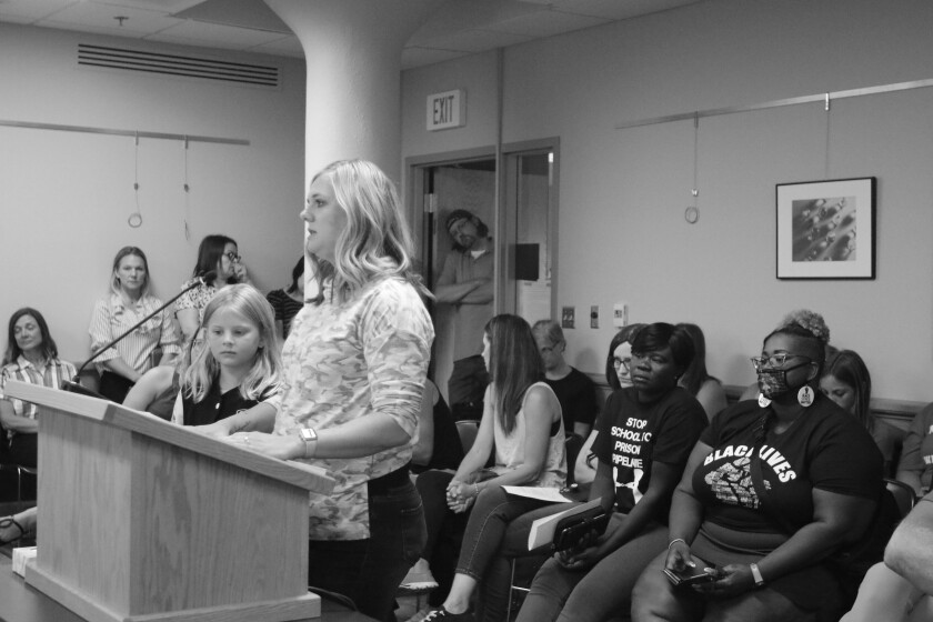 Mother Lisa Esping and her daughter Ellisyn, 8, talking about their experience with masks last year during the Fargo Public School Board meeting on Tuesday, Aug. 10, 2021.jpg
