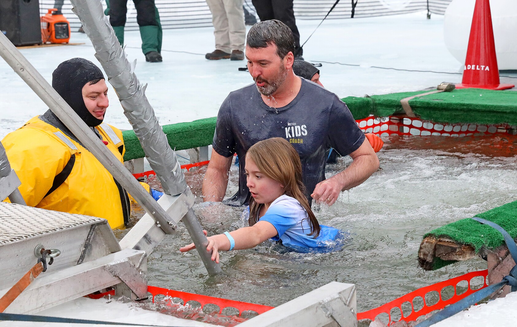 People jump into the water during the Polar Plunge event on Pelican Lake.
