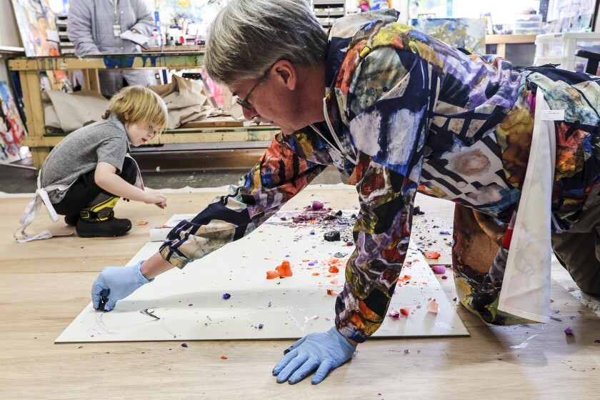 A family creates abstract paintings together in a home studio