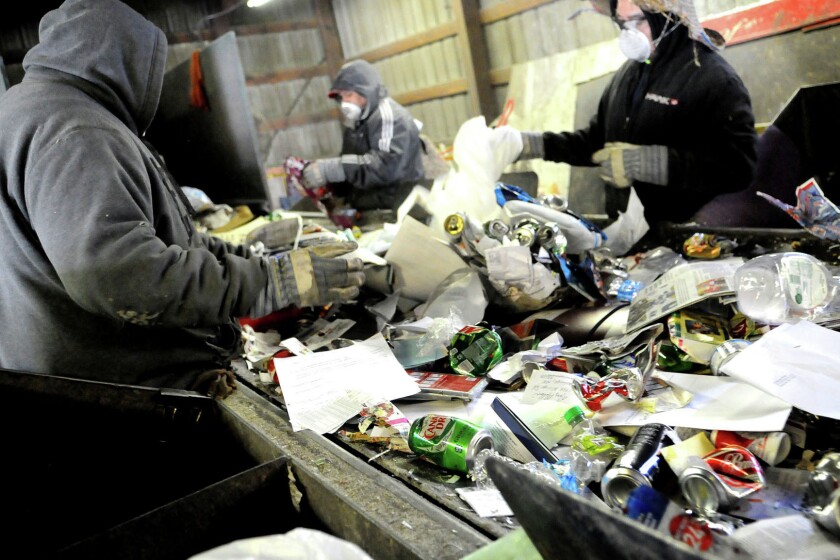 Workers begin the separation of recycled items