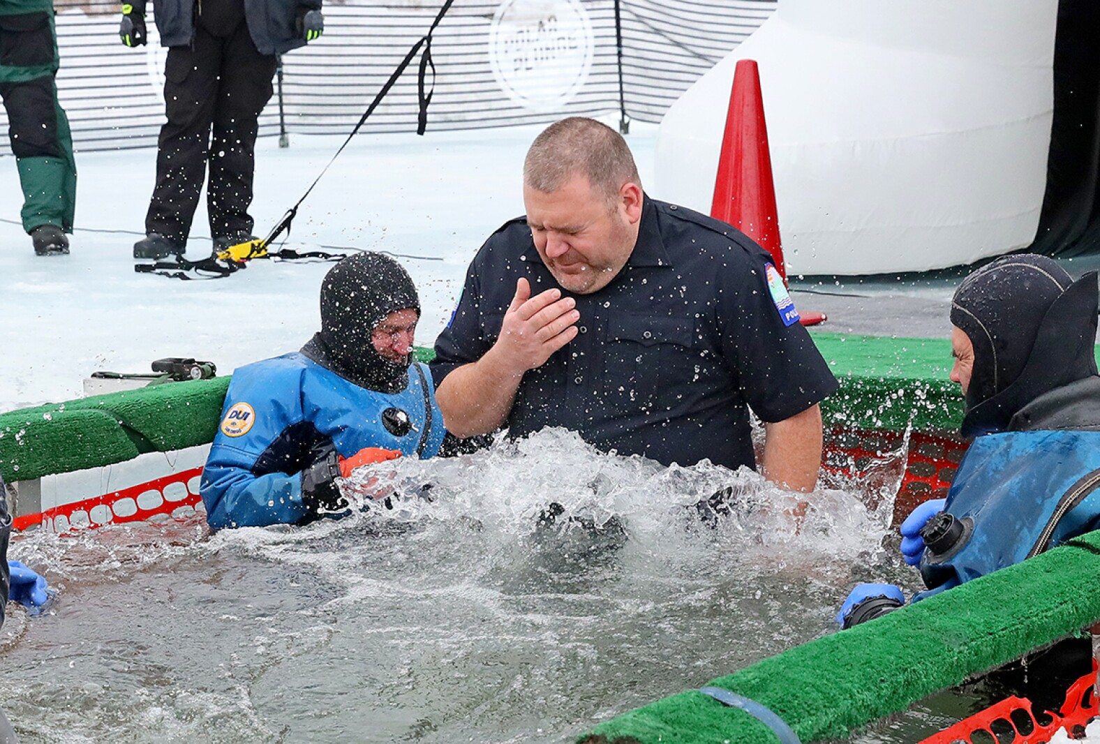 People jump into the water during the Polar Plunge event on Pelican Lake.
