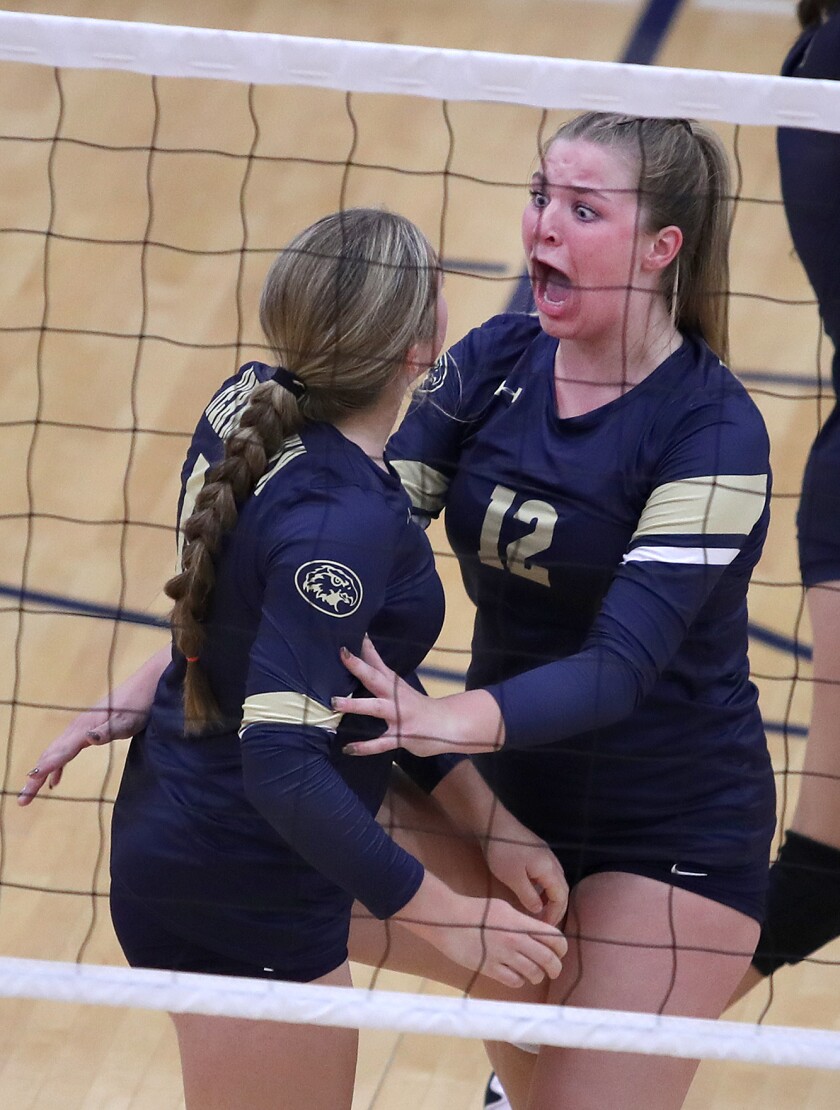 Hermantown’s Gabriella Arntson (12) enthusiastically celebrates a block with Alyssa Yokom (15)
