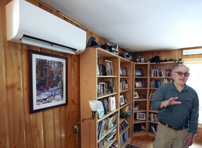 Homeowners Can Use Rebates, Tax Credits To Cut Emissions, But Does Technology Hold Up In Minnesota Winters? - The Bemidji Pioneer 86 Couple and their energy efficient house.