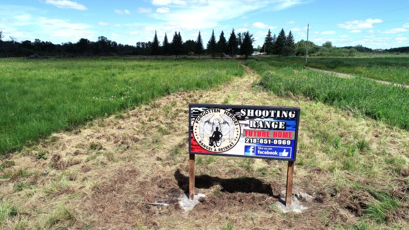The sign stands in the field.