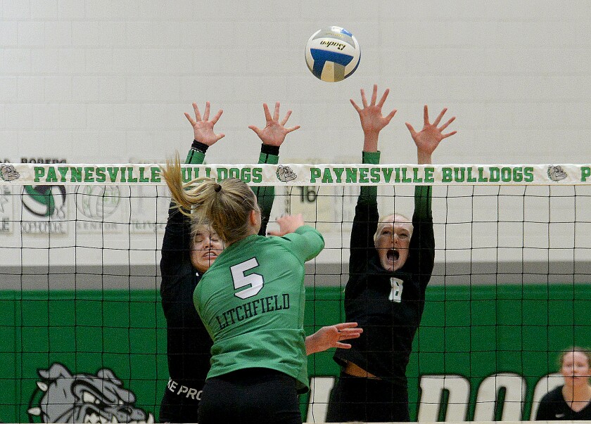 Paynesville junior Maddie Frieler, 8, and sophomore Kaydence Roeske, left, go up to block a shot attempt by Litchfield's Morgan Falling, 5, during a Section 3AA-North semifinal match on Tuesday, Nov. 1, 2022 at Paynesville.