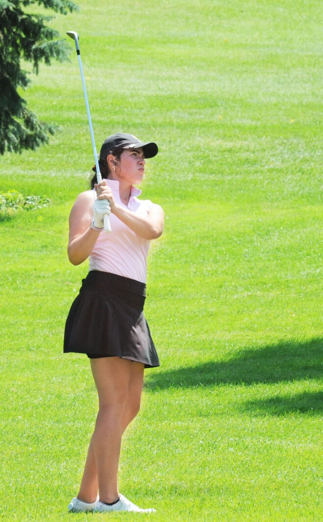 Alayna Eldred watches her pitch shot from just short and left of