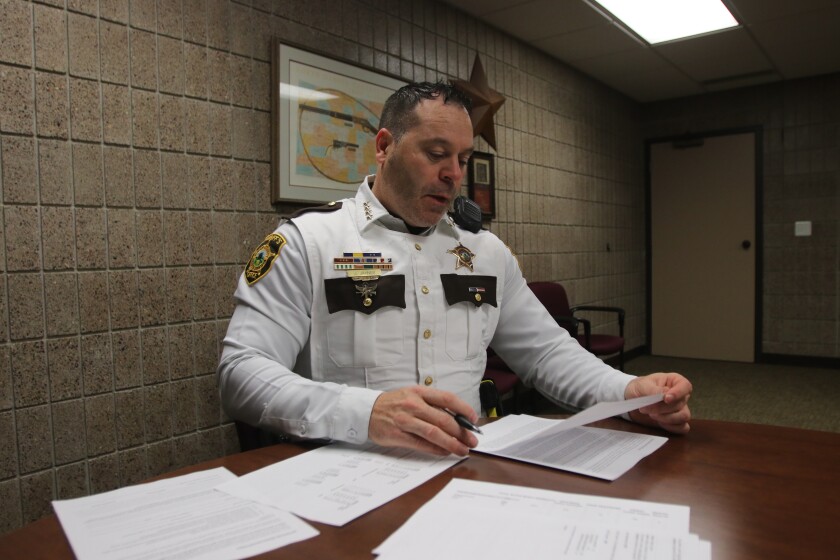 Cass County Sheriff Jesse Jahner going through paperwork on jail statistics on Thursday, Nov. 4, 2021.jpg