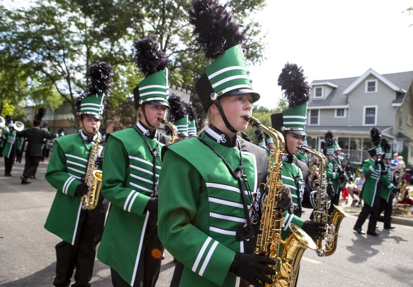 Members of the Litchfield Marching Dragons march down North Armstrong Avenue while participating in the Watercade parade in downtown Litchfield on Saturday, July 9, 2022.