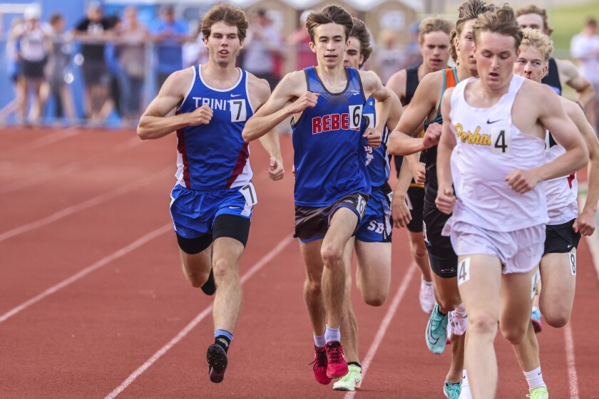 Athletes compete in track and field events at outdoor stadium