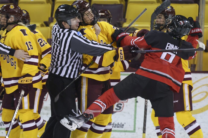 college women compete in hockey game
