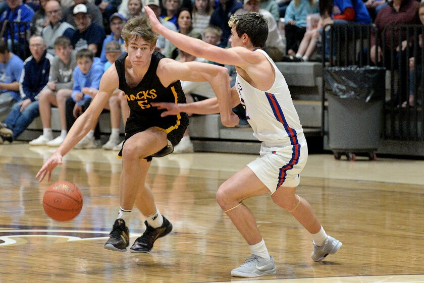 Dawson-Boyd senior Brayson Boike, left, drives past a Hills-Beaver Creek defender in the Section 3A championship on Thursday, March 13, 2025 at the R/A Facility in Marshall.