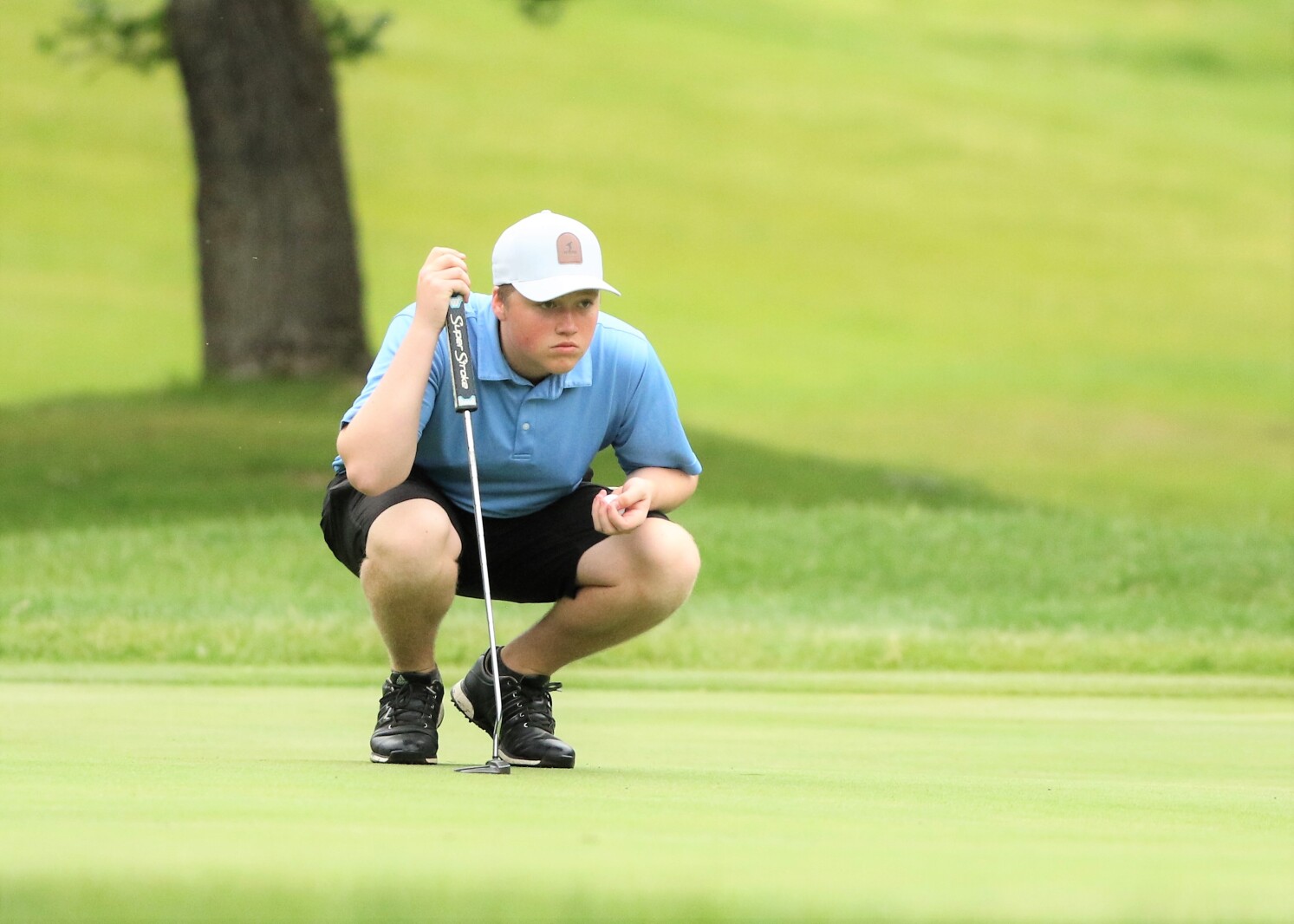A golfer sizes up the green.