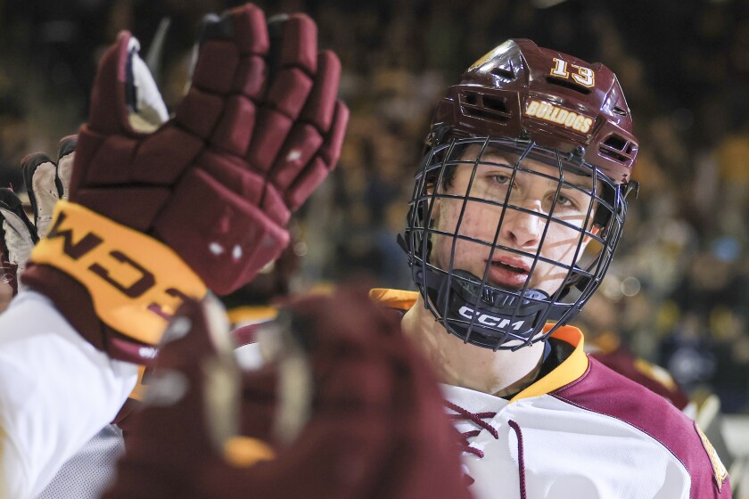 college men play ice hockey