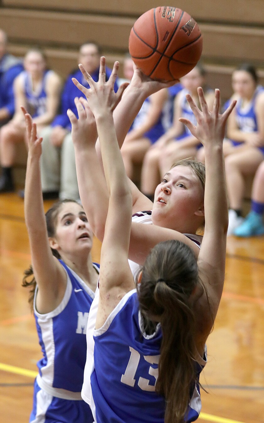 Solon Springs’ Gretchen Hammond (23) shoots over Mellen’s Britta Josephson (13)