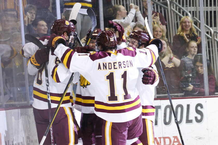 college men play ice hockey indoors