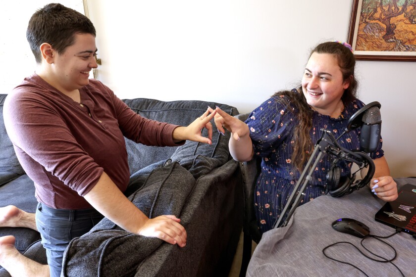 Two women touching finger tips.