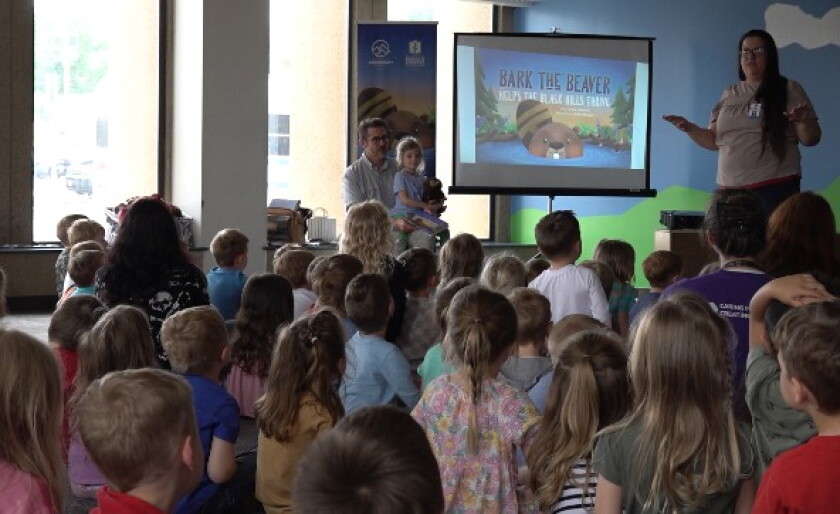 Author Eric Zimmer reads his book to children enrolled in the early learning program at the YMCA of the Black Hills.