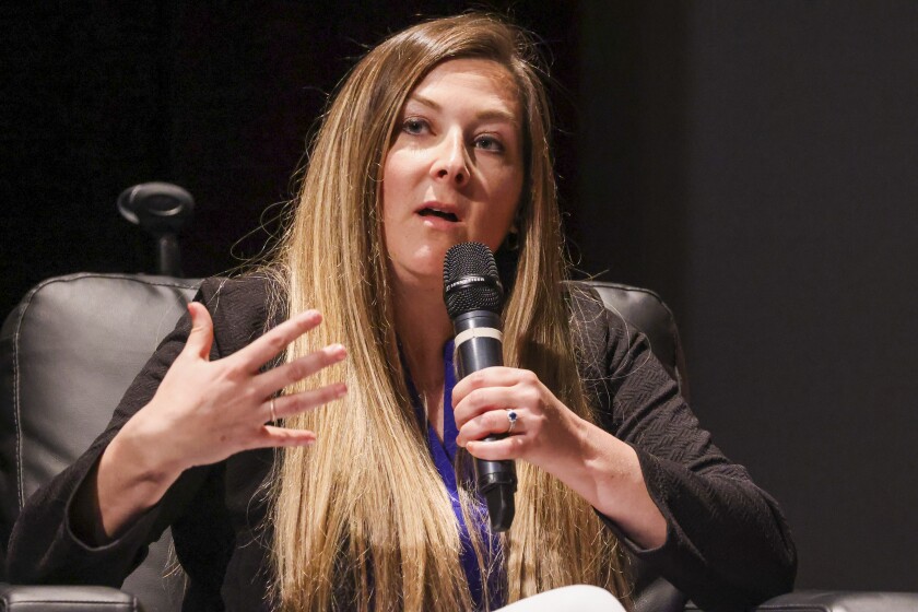 Women participating in live panel on theatre stage