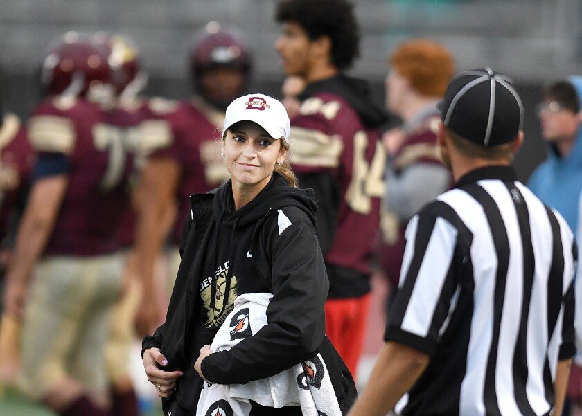 Duluth Denfeld assistant coach Alissa Boyhtari talks to an official during the Hunters game with Rock Ridge