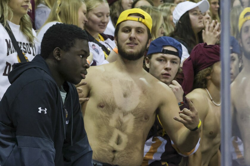 college hockey players play ice hockey