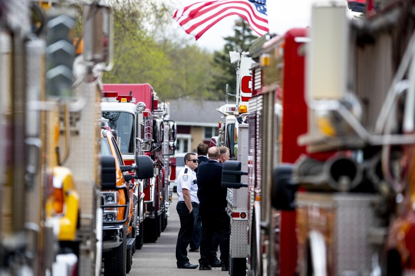 Firefighters stand around to visit with one another outside Refuge Church before the start of firefighter Ryan Leif Erickson's funeral on Friday, May 20, 2022.