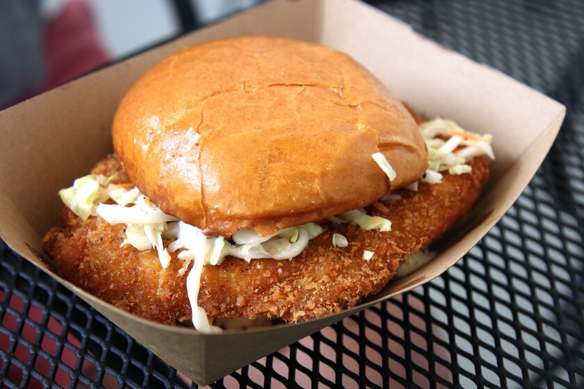 Pork sandwich resting in a paper bowl