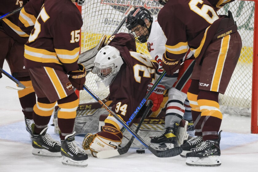 high school boys play ice hockey