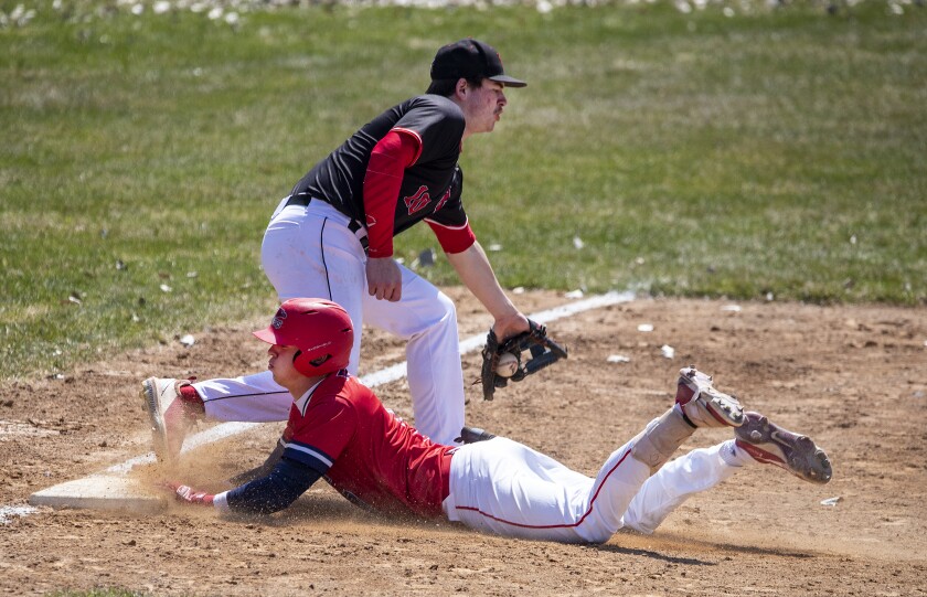 Ridgewater third baseman Brad Bickmann attempts to tag out Eli Roberts of Central Lakes College as he slides into third base during a game at Green Lake Baseball Diamonds in Spicer on Wednesday, April 27, 2022.