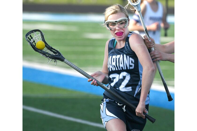 Girl runs during lacrosse game