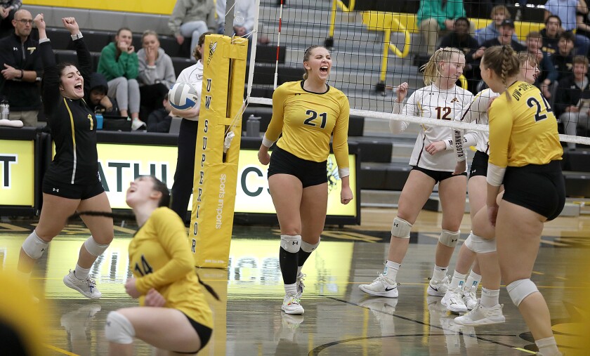 UW-Superior’s Alexie Pryd (21) celebrates a kill with her teammates