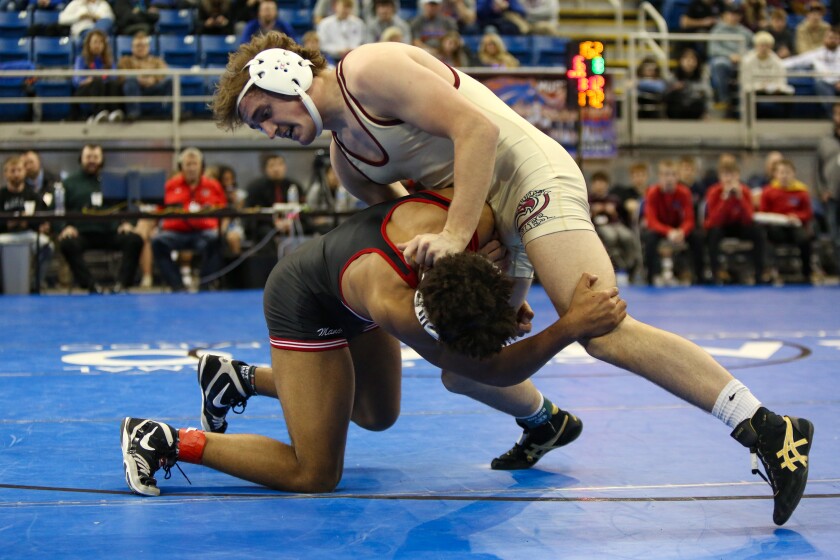 Wyatt Kosidowski of Fargo Davies wrestles Tate Sailer of Mandan in the 172-pound championship match at the North Dakota Class A individual state wrestling championships at the Fargodome on Friday, Feb. 21, 2025.