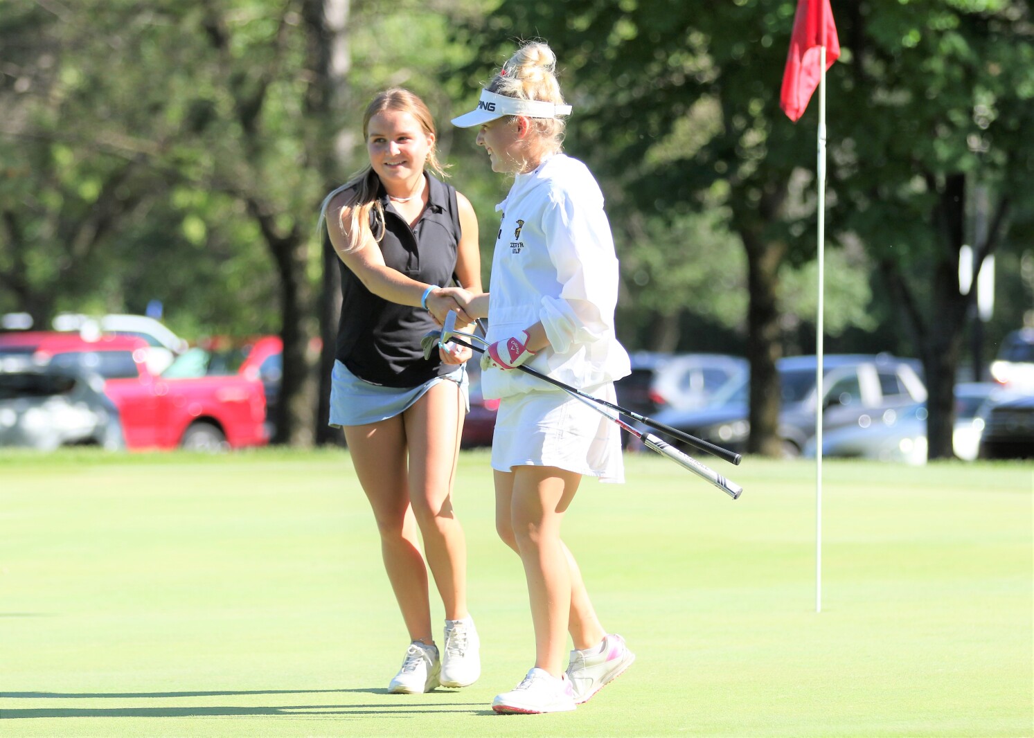 Golfers shake hands.
