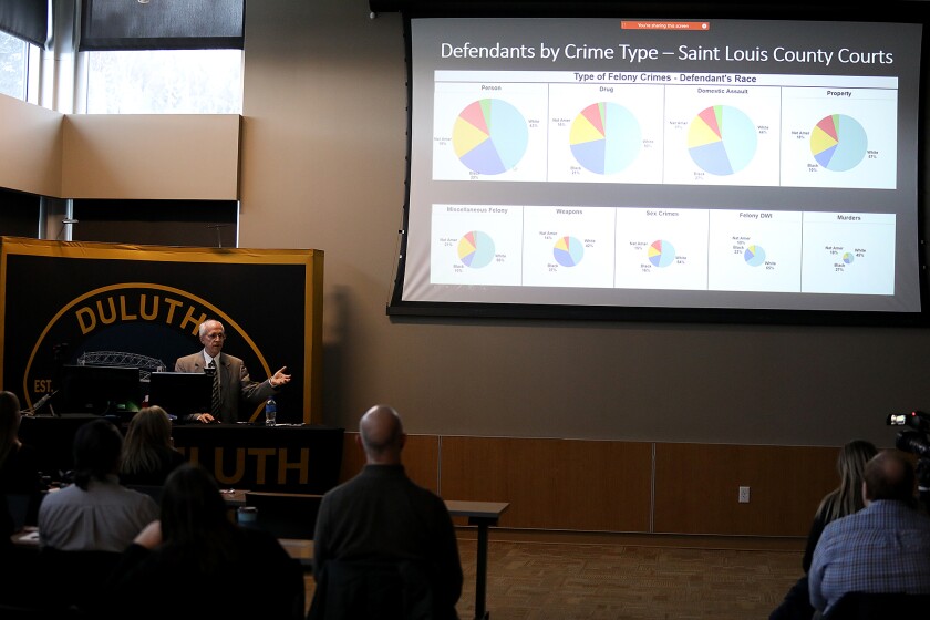 Bob Scales, CEO of Police Strategies LLC, shows the crowd some data as he breaks down a Demographic Disparity Analysis