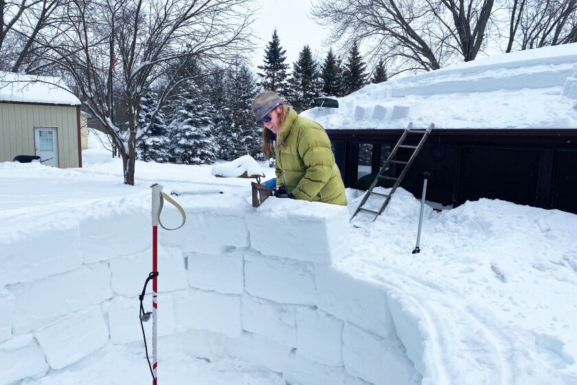 Man building igloo