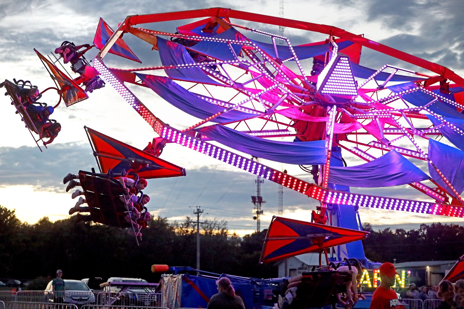The fair midway ride Soarin' spins people around.