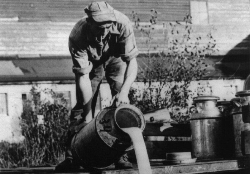 Dairy farmer dumping milk from a truck at unknown location Library of Congress_edited.jpg