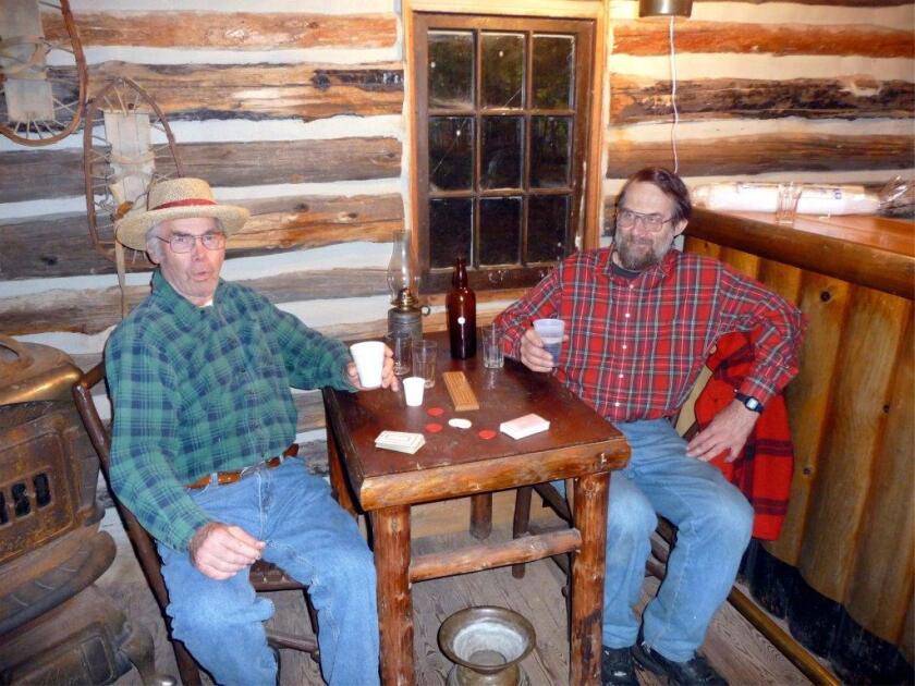 Andy Anderson and Michael Fraser hang out in the saloon during a past Crosslake Artisan Fair. This year’s fair will be Sunday. (Submitted)