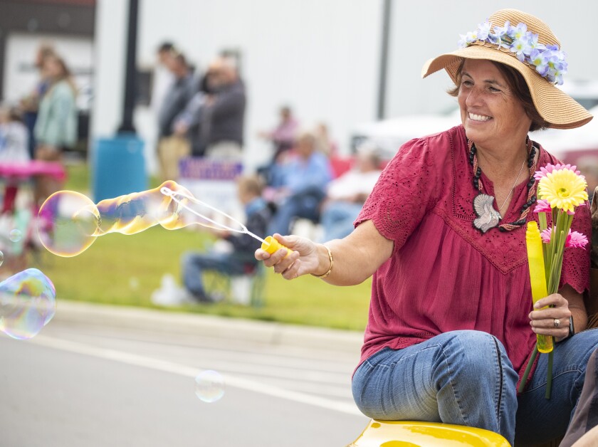 A parade participant blows bubbles while taking part in Saturday's Lake Lillian Fun Days parade on August 6, 2022.