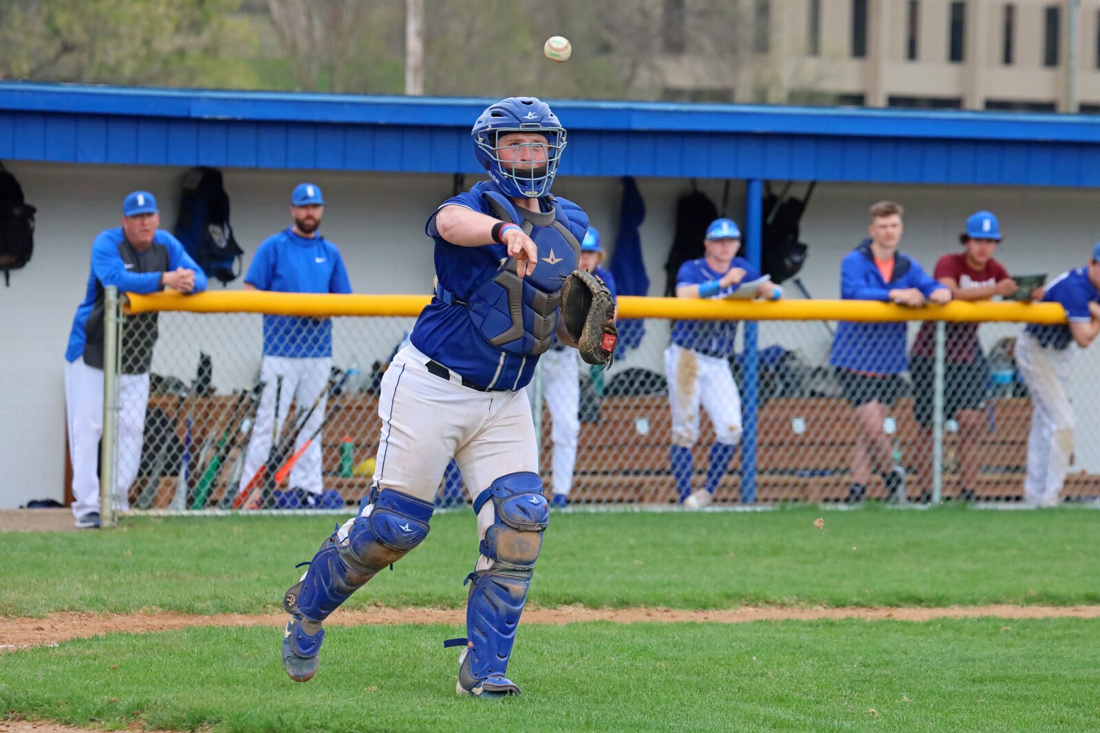 Catcher throws to first.