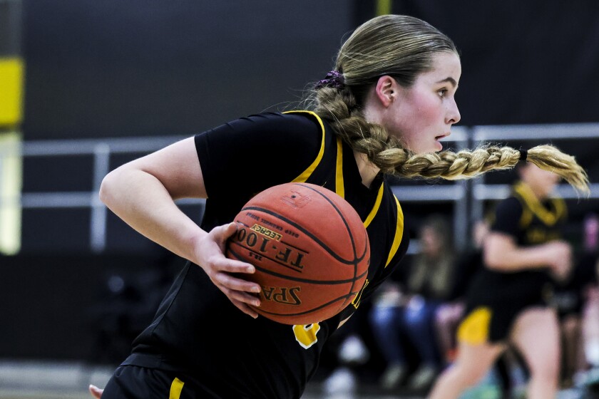 high school girls play basketball