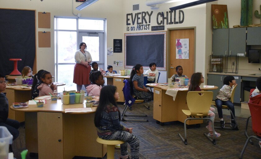 Students listen as they learn that Shameri Drah, a second-grader in Emily Winter's class at Prairie Elementary who won the Wilmont VFW Auxiliary's Illustrating America Coloring Contest, won the regional contest as well.