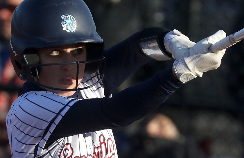 A sliver of light illuminates Superior’s Avery Visger’s eye as she knocks a triple