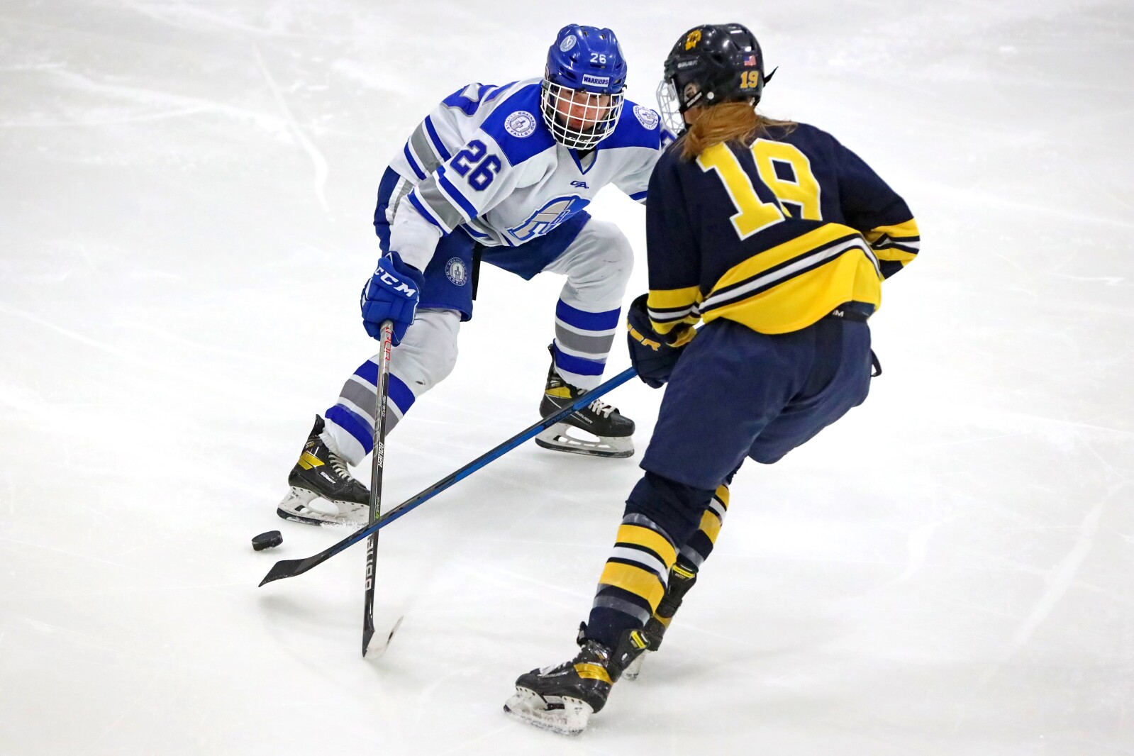 Brainerd/Little Falls' Lucy Peterson gets the puck away from Wayzata's Courtney Jacobs on Friday, Nov. 11, 2022, at Essentia Health Sports Center in Brainerd.