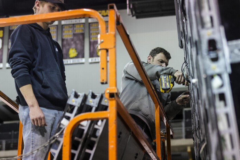 workers install new scoreboard