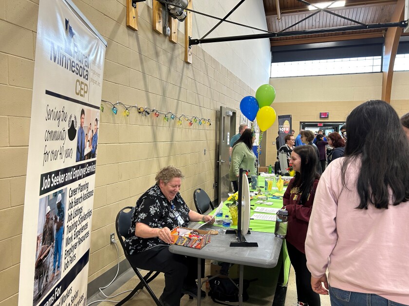 Students check out the Rural Minnesota Concentrated Employment Program Inc. table at the Wadena job fair on Wednesday, April 12, 2023.