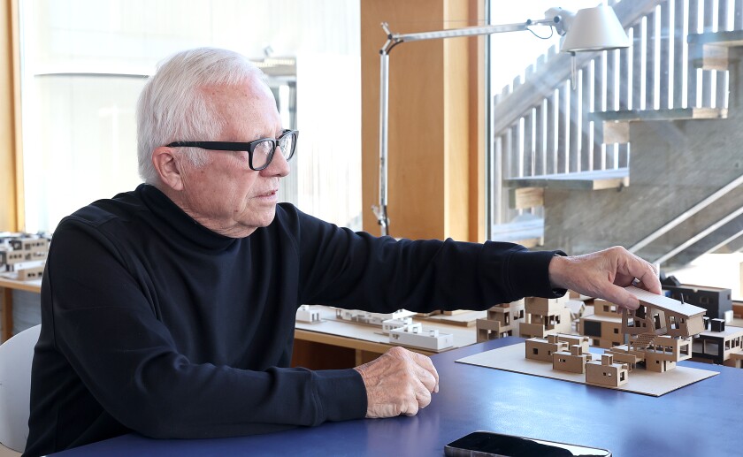 architect looks at model.