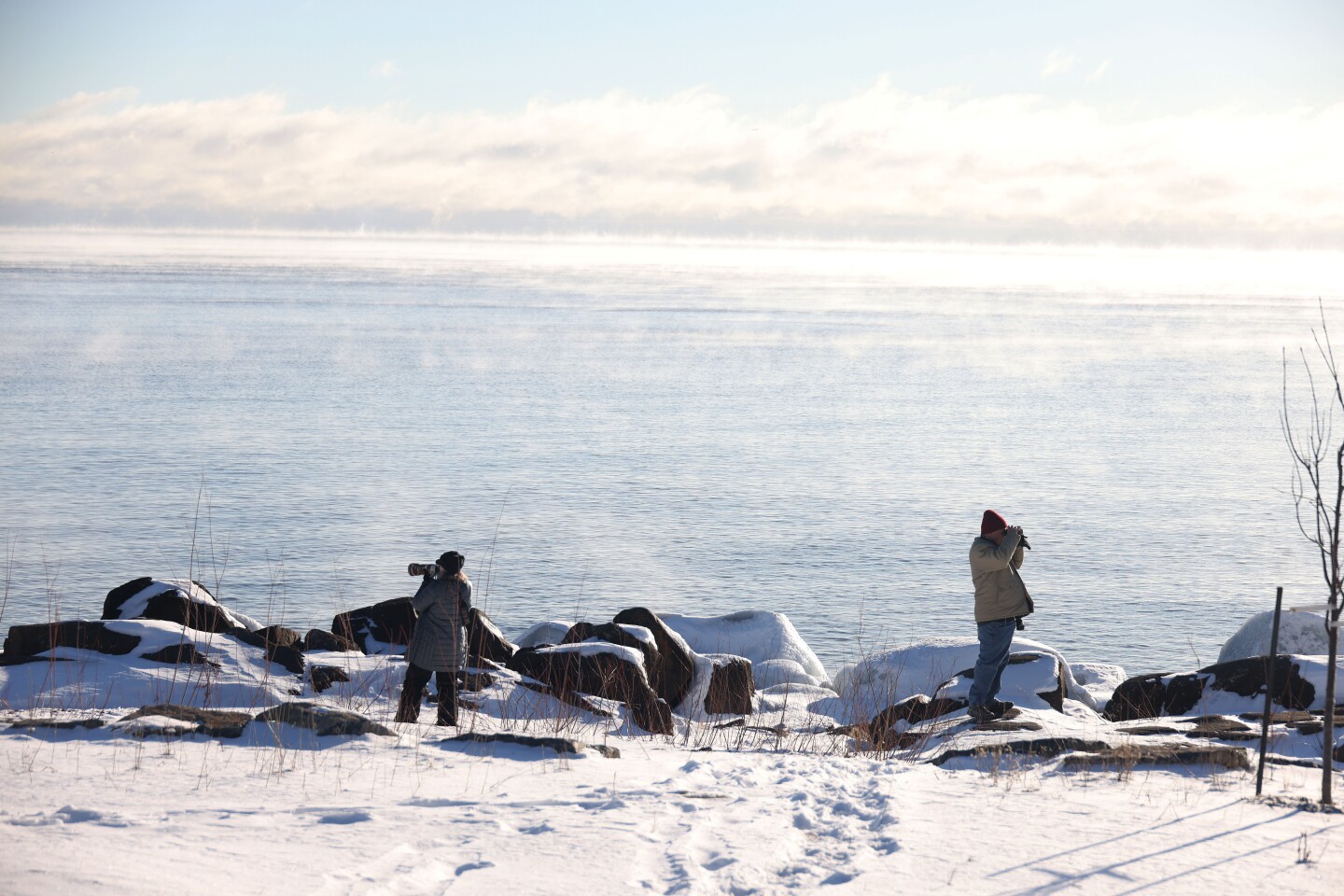 Photographers take photos of sea smoke